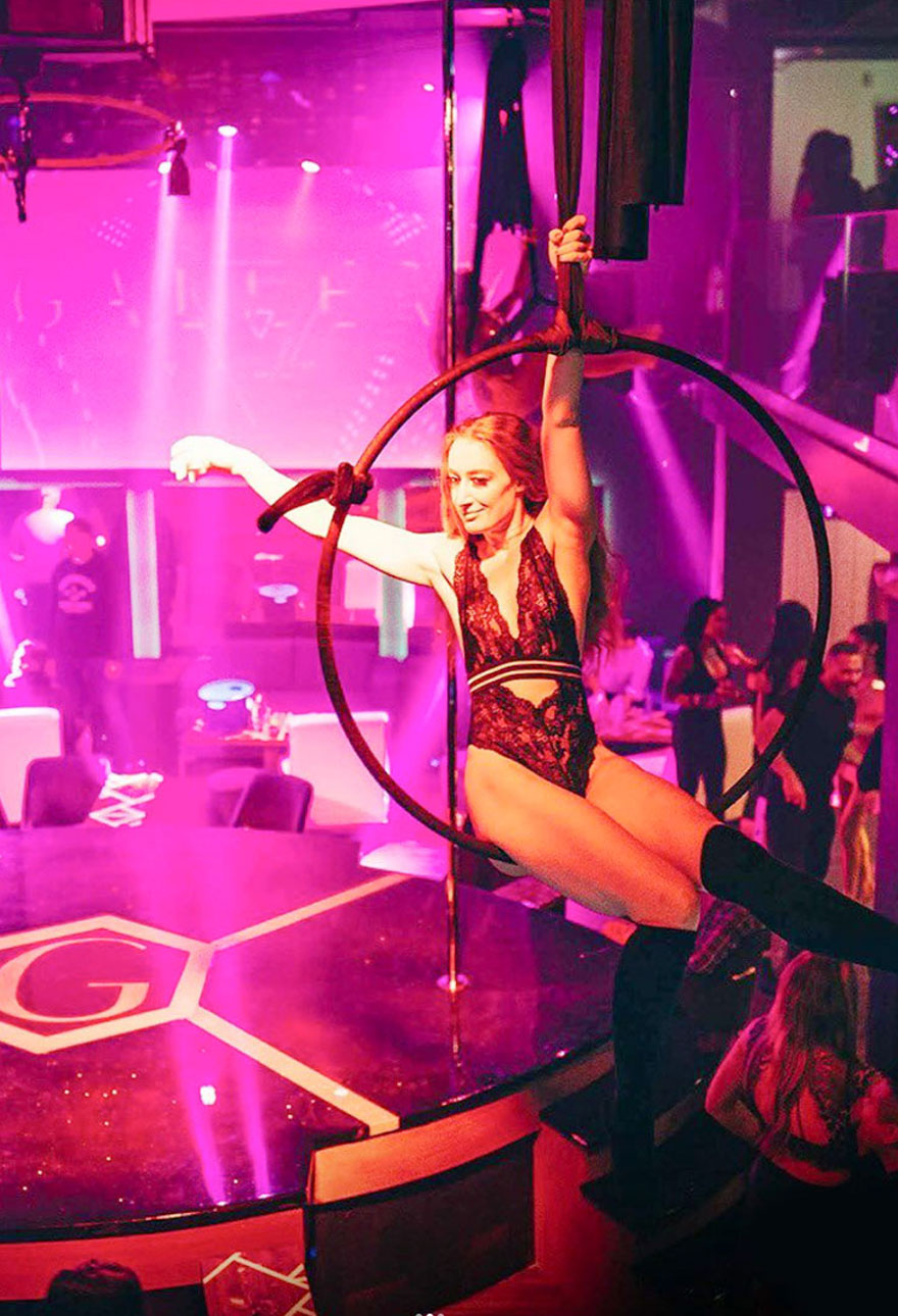 Lady on a Circular Hanger In a Nightclub
